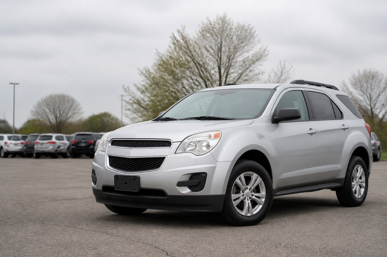 Representative silver early-2010s compact crossover parked in a dealership lot